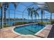 The pool is screened-in and overlooks a waterway with neighborhood homes in the distance at 5321 Fishersound Ln, Apollo Beach, FL 33572