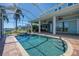 The screened pool and patio include a spa, outdoor kitchen, ceiling fans, and views of the waterfront at 5321 Fishersound Ln, Apollo Beach, FL 33572