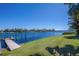 Waterfront property with a private dock and lush green lawn, offering serene water views at 5321 Fishersound Ln, Apollo Beach, FL 33572