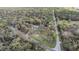 Expansive wooded lot featuring a charming home, circular drive and private fire pit area at 5419 Cyril Dr, Dade City, FL 33523
