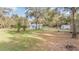 Expansive backyard showcasing mature trees and a charming home, creating a serene outdoor living space at 5419 Cyril Dr, Dade City, FL 33523