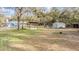Picturesque backyard with a versatile shelter and storage shed, offering ample space for outdoor activities at 5419 Cyril Dr, Dade City, FL 33523
