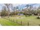 Expansive fenced backyard features a fire pit and mature trees, perfect for outdoor gatherings at 5419 Cyril Dr, Dade City, FL 33523