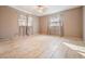 This bedroom features large windows, tile flooring, and neutral paint, creating a bright and inviting space at 5419 Cyril Dr, Dade City, FL 33523