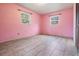 This is an empty bedroom with pink walls and modern tile floors, ready for personalization at 5419 Cyril Dr, Dade City, FL 33523