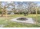 Inviting outdoor space featuring a custom fire pit with pavers, perfect for cozy evenings under the stars at 5419 Cyril Dr, Dade City, FL 33523