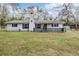Charming single-story home with a white brick facade, black shutters and a cozy front porch at 5419 Cyril Dr, Dade City, FL 33523