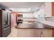 Bright kitchen with stainless steel appliances, white cabinetry, and a butcher block countertop at 5419 Cyril Dr, Dade City, FL 33523