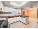 Bright kitchen features white cabinets, a skylight, and an adjacent dining area at 5419 Cyril Dr, Dade City, FL 33523