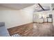 Living room featuring modern laminate floors, a comfortable couch, and an efficient mini-split AC system at 5419 Cyril Dr, Dade City, FL 33523