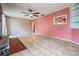 This is a spacious living room featuring neutral tile floors, a ceiling fan and a brick fireplace at 5419 Cyril Dr, Dade City, FL 33523