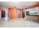 Open-concept living room and kitchen with tile floors and white cabinets at 5419 Cyril Dr, Dade City, FL 33523