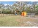 Outbuildings with fenced enclosure, offering additional storage and animal keeping at 5419 Cyril Dr, Dade City, FL 33523
