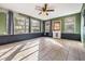 Sun room featuring tile flooring, large windows, and a ceiling fan at 5419 Cyril Dr, Dade City, FL 33523