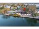 Waterfront property featuring a boat lift, canal access and a backyard deck at 56 Sandpiper Rd, Tampa, FL 33609