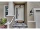 Inviting front entrance with stone steps and a decorative light fixture above the door at 5611 S Russell St, Tampa, FL 33611