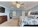 Bright main bedroom with plush carpet, natural light, ceiling fan, and light blue paint at 5611 S Russell St, Tampa, FL 33611