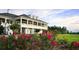 View of a community clubhouse showcasing lawn with roses in full bloom at 5820 Creek Ridge Rd, Brooksville, FL 34601