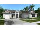 Beautiful new home with landscaped yard and brick paver driveway on a sunny day at 5820 Creek Ridge Rd, Brooksville, FL 34601