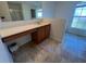 Bright bathroom with a large vanity, sink, and a view from the window at 6283 Lorraine Ln, Spring Hill, FL 34608