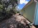 Side view of the home with a pathway, showing the home's placement and access at 6283 Lorraine Ln, Spring Hill, FL 34608