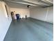 Organized and spacious garage features clean epoxy flooring and ample room for vehicles and storage at 6283 Lorraine Ln, Spring Hill, FL 34608