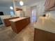 Bright kitchen featuring an island with a sink, ample counter space, and a view of the living area at 6283 Lorraine Ln, Spring Hill, FL 34608