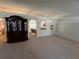 Spacious living room featuring carpeted floors, archways, and a built-in display cabinet at 6283 Lorraine Ln, Spring Hill, FL 34608