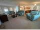 Spacious living room featuring a carpet, neutral-colored walls, and open archways at 6283 Lorraine Ln, Spring Hill, FL 34608
