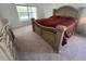 Elegant main bedroom with an ornate bed frame, soft carpet, and natural light at 6283 Lorraine Ln, Spring Hill, FL 34608