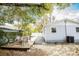 Outdoor patio area featuring lush landscaping, mature trees, and a shaded backyard at 6906 N Central Ave, Tampa, FL 33604