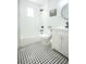 This bathroom features white subway tiles, a modern sink and vanity and black and white tile floors at 6906 N Central Ave, Tampa, FL 33604