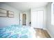 Bright bedroom with closet, light hardwood floors and picture frames that decorate the light, relaxing space at 6906 N Central Ave, Tampa, FL 33604