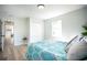 Bedroom features two windows, wood-look floors, access to hallway, and large closet at 6906 N Central Ave, Tampa, FL 33604