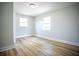 The bedroom boasts light hardwood floors and two windows that give plenty of natural light at 6906 N Central Ave, Tampa, FL 33604