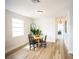 Bright dining area with wood-look floors and view to bedroom and hallway at 6906 N Central Ave, Tampa, FL 33604