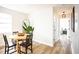 Bright dining area with wood-look floors and view to bedroom and bathroom at 6906 N Central Ave, Tampa, FL 33604