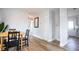 Bright dining area with wood-look floors and view to bedroom and kitchen at 6906 N Central Ave, Tampa, FL 33604
