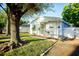 Charming single-story home with a cozy front porch and beautifully landscaped yard at 6906 N Central Ave, Tampa, FL 33604