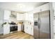 Updated kitchen featuring white cabinets, stainless steel appliances, and modern design elements at 6906 N Central Ave, Tampa, FL 33604