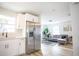 An open kitchen overlooking the living room showcasing stainless steel appliances and an open floorplan at 6906 N Central Ave, Tampa, FL 33604