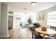 Open-concept living space features wood-look flooring, white walls, and modern furnishings at 6906 N Central Ave, Tampa, FL 33604