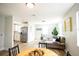 Open-concept living space features wood-look flooring, white walls, and stainless steel appliances at 6906 N Central Ave, Tampa, FL 33604