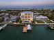 Aerial view of a waterfront estate featuring a private pool, lush landscaping, and a boat dock at 6976 S Shore S Dr, St Petersburg, FL 33707