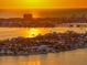 Breathtaking sunset view over the water, highlighting the property's prime waterfront location and coastal charm at 6976 S Shore S Dr, St Petersburg, FL 33707