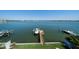 Breathtaking waterfront view of the Gulf Coast from a lush backyard with docks and boat lift at 6976 S Shore S Dr, St Petersburg, FL 33707