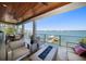 Relaxing outdoor living space with a fireplace, comfortable seating and beautiful views at 6976 S Shore S Dr, St Petersburg, FL 33707