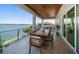 Spacious balcony with wood ceiling and dining table with stunning water views at 6976 S Shore S Dr, St Petersburg, FL 33707