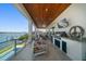 Spacious balcony features a built-in grill, outdoor seating, and stunning water views at 6976 S Shore S Dr, St Petersburg, FL 33707