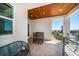 Cozy balcony with a table and chairs, offering scenic water views for a peaceful retreat at 6976 S Shore S Dr, St Petersburg, FL 33707